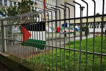Pro-Palestinian flag and signs at the University of Milan, Italy. Credit: Saggittarius A via Wikimedia Commons.