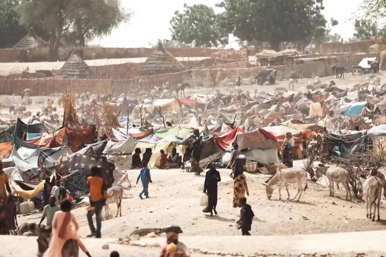 A screenshot from a “Voice of America” report on those who have fled Sudan for refugee camps in Chad as part of an ongoing civil war, May 16, 2023. Credit: Henry Wilkins/VOA via Wikimedia Commons.