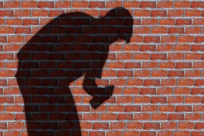 Shadow of a person about to spray a wall with graffiti. Credit: Gerd Altmann/Pixabay.