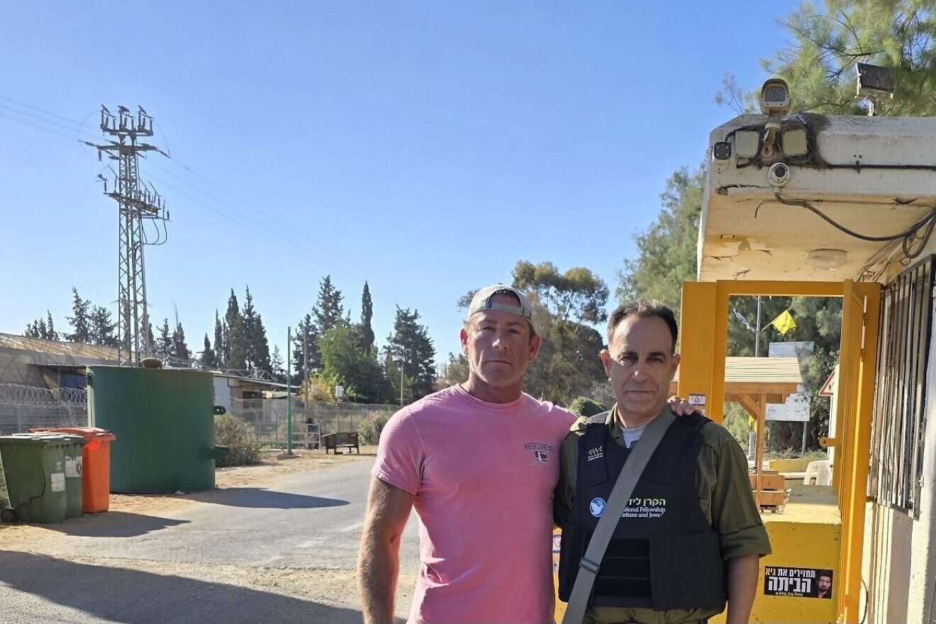 Jason Greenberg (left), whose cousins were taken hostage on Oct. 7, 2023, poses during a subsequent trip to Kibbutz Nir Oz in Israel in October 2024. Credit: Jason Greenberg.