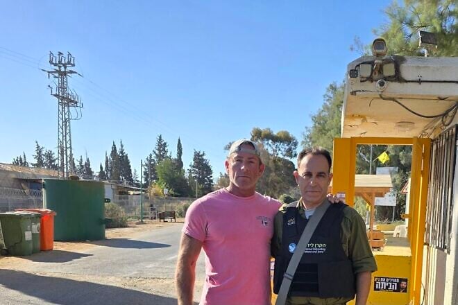 Jason Greenberg (left), whose cousins were taken hostage on Oct. 7, 2023, poses during a subsequent trip to Kibbutz Nir Oz in Israel in October 2024. Credit: Jason Greenberg.