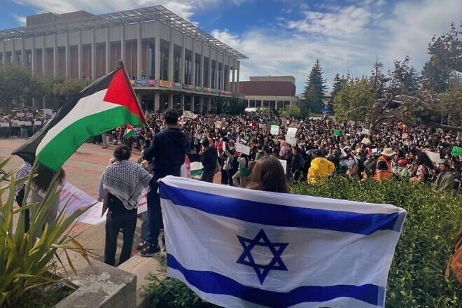 Simone Beilin, a freshman at the University of California, Berkeley, is draped in an Israeli flag as she confronts anti-Israel protesters on campus, Oct. 18, 2023. Credit: Courtesy.