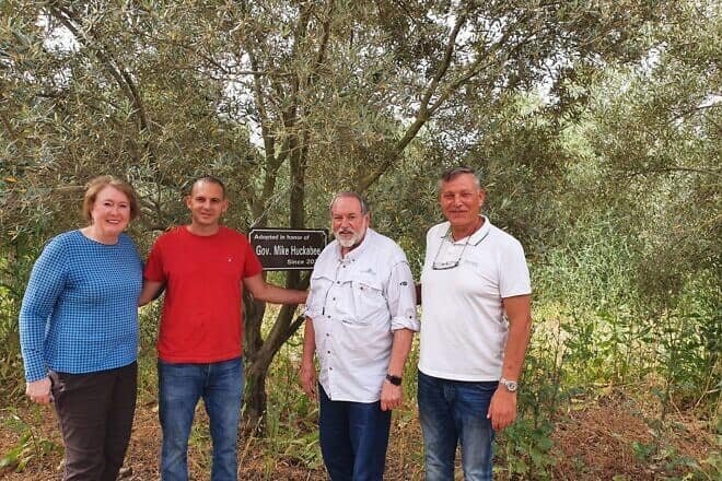 Former Arkansas Gov. Mike Huckabee (third from left) and his wife Janet with olive-grove farmer Gal Ashush (second from left) and My Tree in Israel founder Kobi Assaf in 2022. Credit: Courtesy/My Tree in Israel Archive Photo.