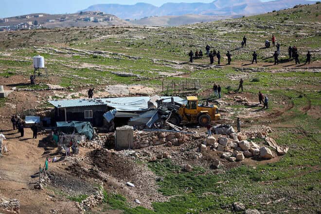 An Israeli bulldozer demolishes an illegally built farm shed in the Palestinian settlements of Masafer Yatta near Hebron, Feb. 27, 2020. Photo Wisam Hashlamoun/Flash90.