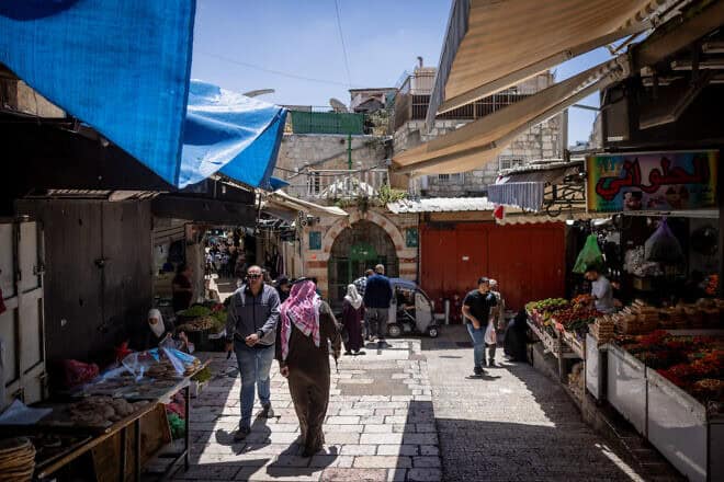 An Arab man walks through the Old City of Jerusalem, the evening before the start of the Jewish holiday of Passover. April 21, 2024. Photo by Chaim Goldberg/Flash90.