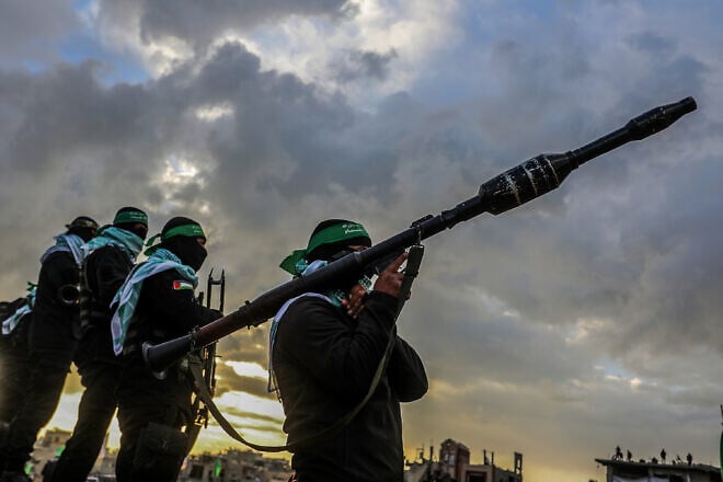 Hamas terrorists amid a transfer of four bodies of Israeli hostages, whom Hamas murdered, to Israel, Gaza, Feb. 20, 2025. Credit: Abed Rahim Khatib/Flash90.