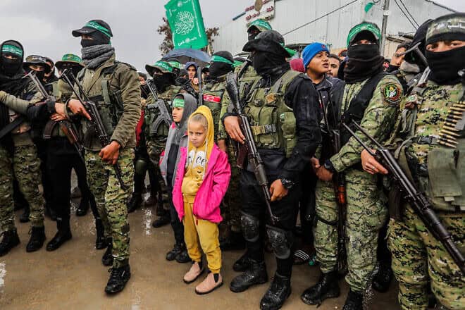 Members of the Al-Qassam Brigades hand over Israeli hostages to the Red Cross, as part of the ceasefire agreement between Israel and Hamas, in Rafah, Feb. 22, 2025. Photo by Abed Rahim Khatib/Flash90.