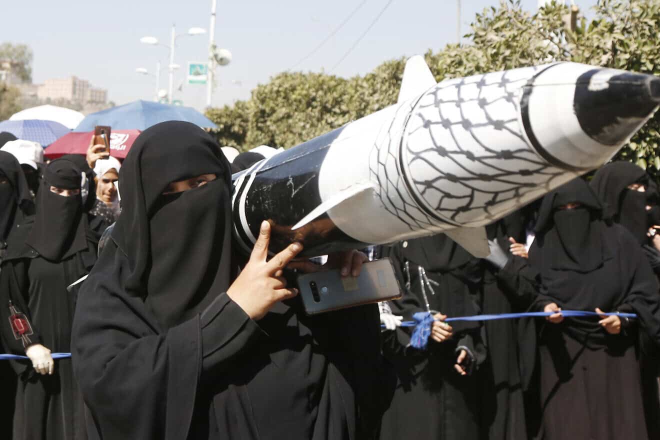 A female student from Sanaa University carries a mock missile during a protest staged in Yemen to welcome the ceasefire agreement in Gaza, on Jan. 22, 2025. Photo by Mohammed Hamoud/Getty Images.