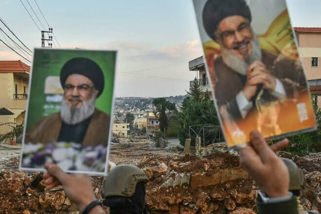Residents of the southern Lebanese village of Aitaroun lift portraits of Hezbollah's slain leader Hassan Nasrallah, Jan. 27, 2025. Photo by Fadel Itani/AFP via Getty Images.