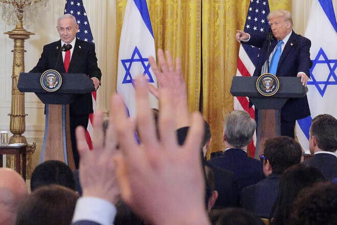 Reporters raise hands to ask questions as Israeli Prime Minister Benjamin Netanyahu and U.S. President Donald Trump speak during a joint press conference held in the East Room of the White House on Feb. 4, 2025 in Washington, D.C. Photo by Chip Somodevilla/Getty Images.