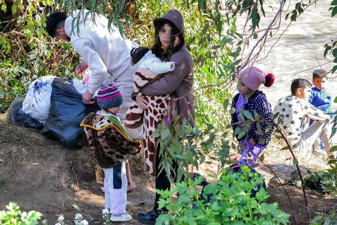 Syrian Alawites cross the Nahr al-Kabir river and enter Lebanon, fleeing sectarian violence in their homeland, on March 11, 2025. Photo by Fathi al-Masri/AFP via Getty Images.