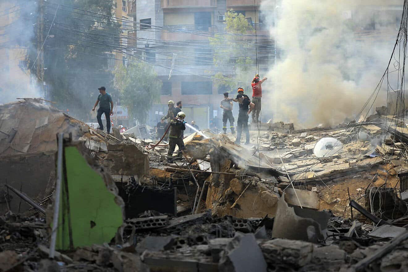 A firefighter sprays water on rubble after an Israeli Air Force strike in southern Beirut on March 28, 2025. Photo by AFP via Getty Images.