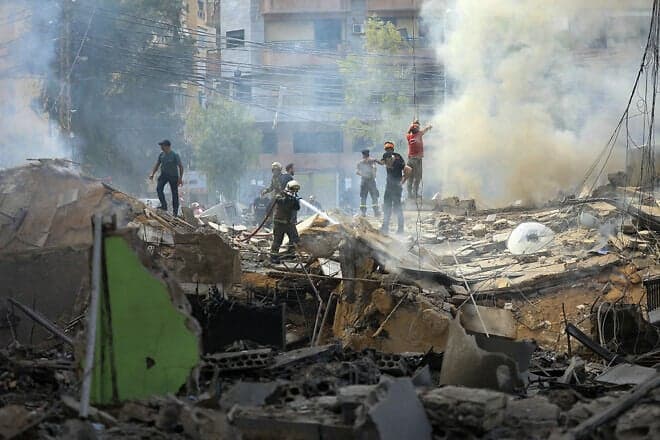 A firefighter sprays water on rubble after an Israeli Air Force strike in southern Beirut on March 28, 2025. Photo by AFP via Getty Images.