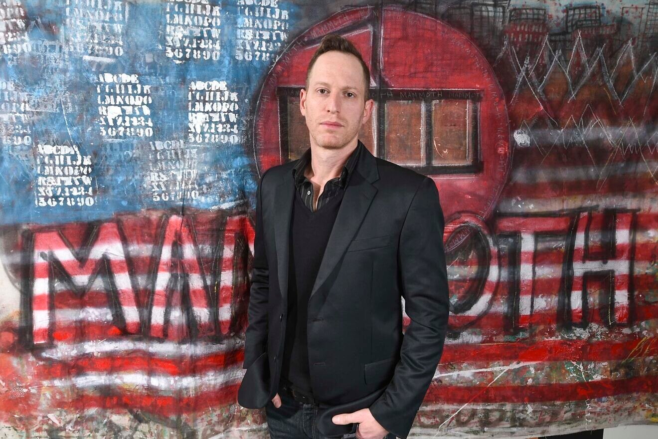 Lior Geller posing with artwork by Toby Lee Jones at the 2nd Annual Mammoth Film Festival in California, Feb. 9, 2019. Photo by Michael Bezjian/Getty Images for 2019 Mammoth Film Festival.