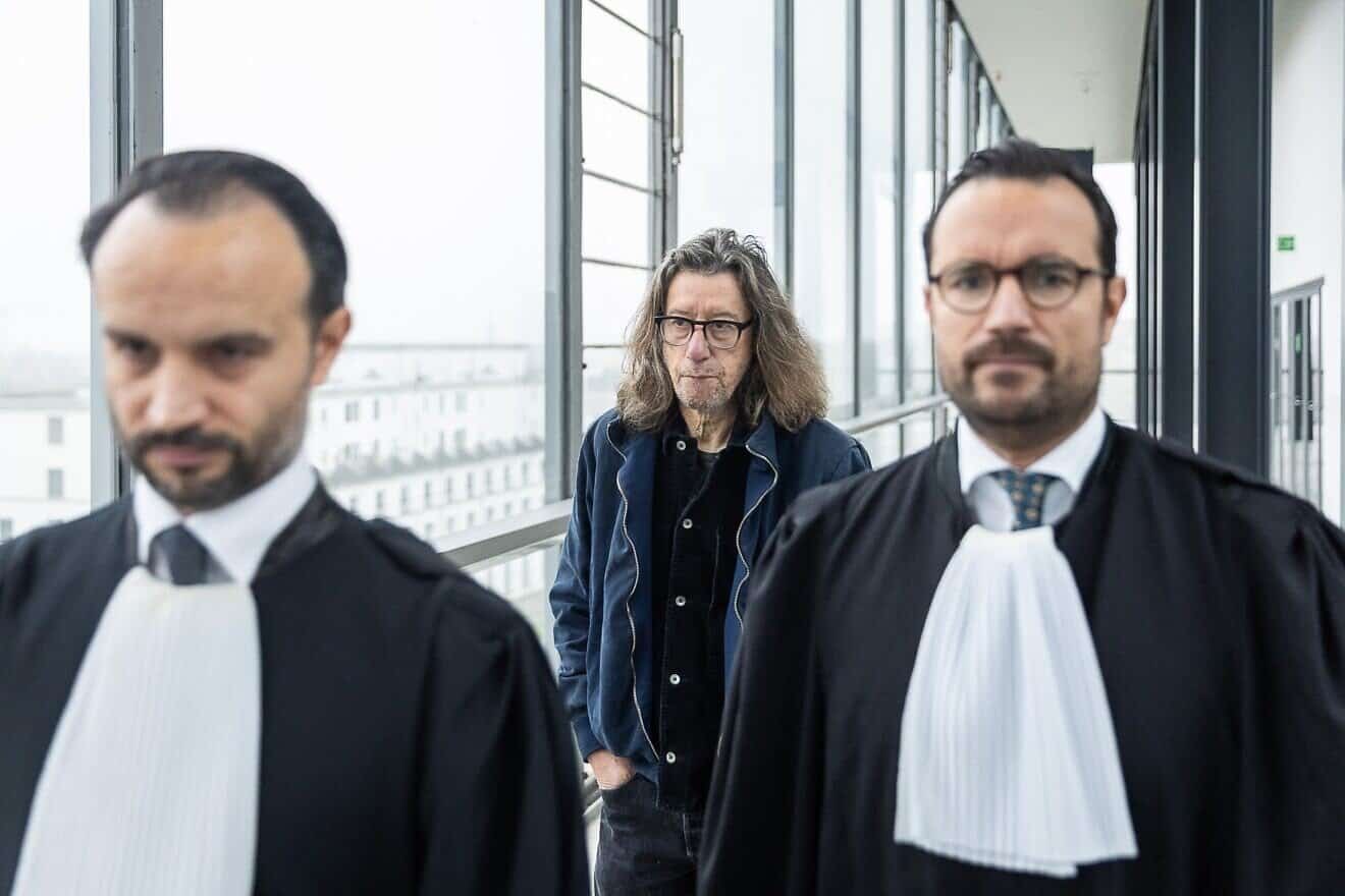 Belgian writer Herman Brusselmans and his attorneys at the Gent Correctional Court, on Nov. 5, 2024. Photo by James Arthur Gekiere/BELGA MAG/AFP via Getty Images.