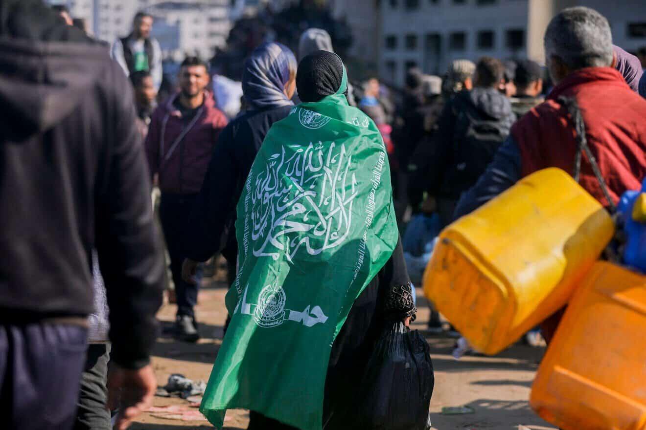 A Hamas terrorist walks along Gaza's Al-Rashid Street to cross the Netzarim Corridor from the southern Gaza Strip to the north, on Jan. 27, 2025. Photo by Youssef Alzanoun/Middle East Images/AFP via Getty Images.