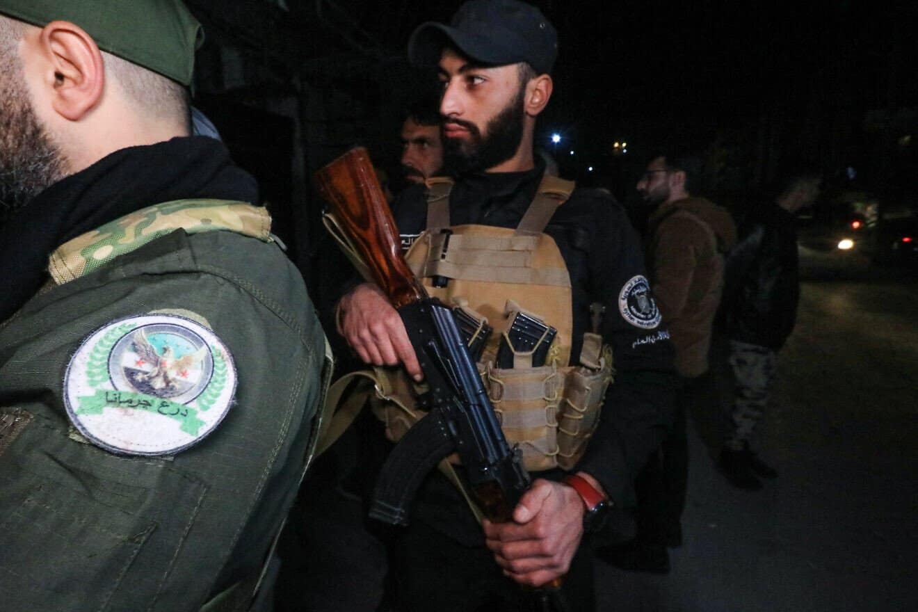 Members of Syria's new authorities security forces at a checkpoint as they deploy in the Druze and Christian majority Jaramana suburb of Damascus, on March 2, 2025. Photo by Bakr Alkasem/AFP via Getty Images.