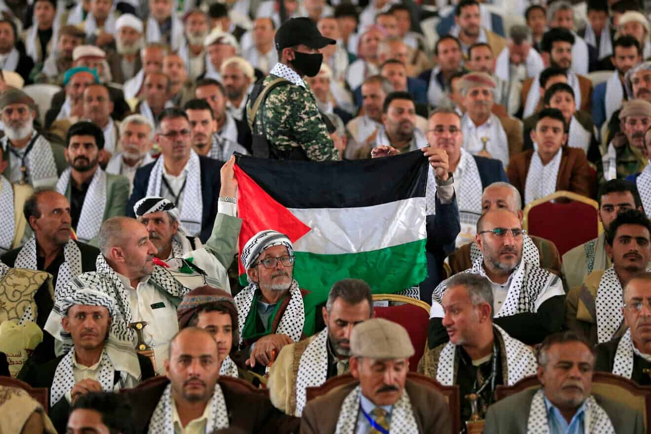 Participants raise a Palestinian flag during the third conference entitled "Palestine is the central issue of the nation", organized by Yemen's Houthi rebels, in Sanaa on March 22, 2025. Photo by Mohammed Huwais/AFP via Getty Images.
