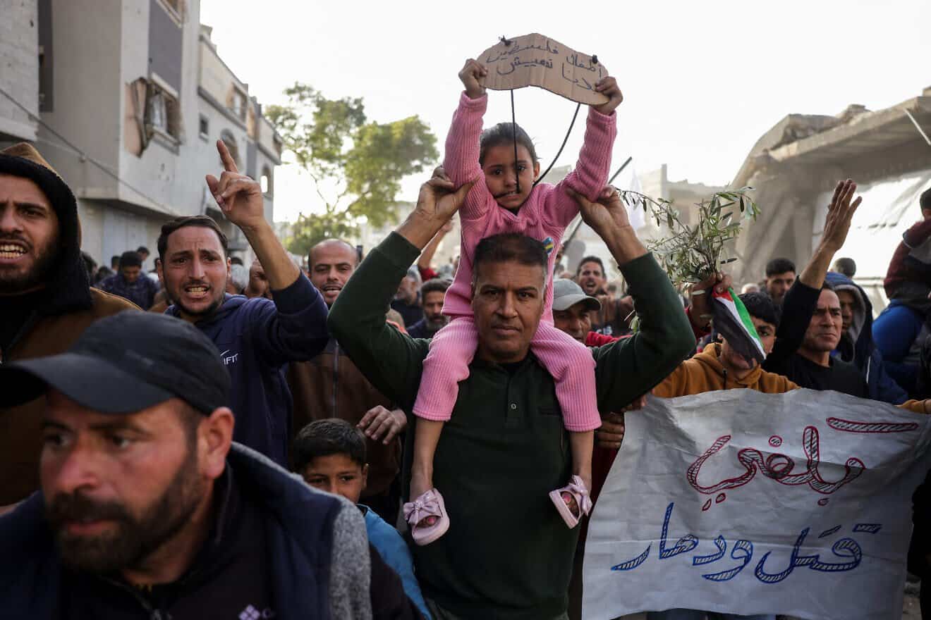 A slogan in Arabic reading (right): "Enough killing and destruction" and another reading (left): "The children of Palestine: We want to live" are displayed during a rally calling for an end to the war, in Beit Lahia, in the northern Gaza Strip, on March 25, 2025. Photo by AFP via Getty Images.
