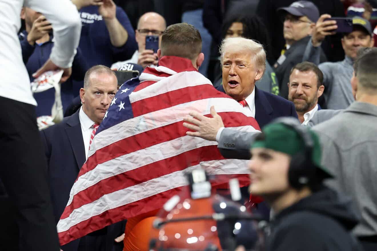 U.S. President Donald Trump congratulates Wyatt Hendrickson of the Oklahoma State Cowboys after winning the 285 pound (129 kg.) championship match at the 2025 NCAA Division I Wrestling Championships in Philadelphia on March 22, 2025. Photo by Hunter Martin/Getty Images.