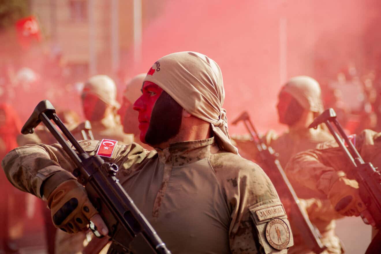 Turkish soldiers stand at attention as red smoke fills the air during Republic Day celebrations in Kayseri on Oct. 29, 2024. Photo by Damoun Pournemati/Middle East Images/AFP via Getty Images.