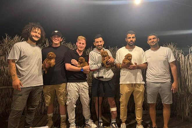 Veterans of the Israel Defense Forces with trainee pups in the Dogs 4 Soldiers program. Credit: Courtesy of Liran Dimri/Belev Echad.