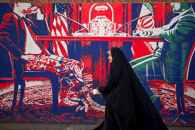 Iranians pass by anti-American murals painted on the walls of the former U.S. embassy in Tehran, April 16, 2025. Photo by Mohammadali Najib/Middle East Images/AFP via Getty Images.