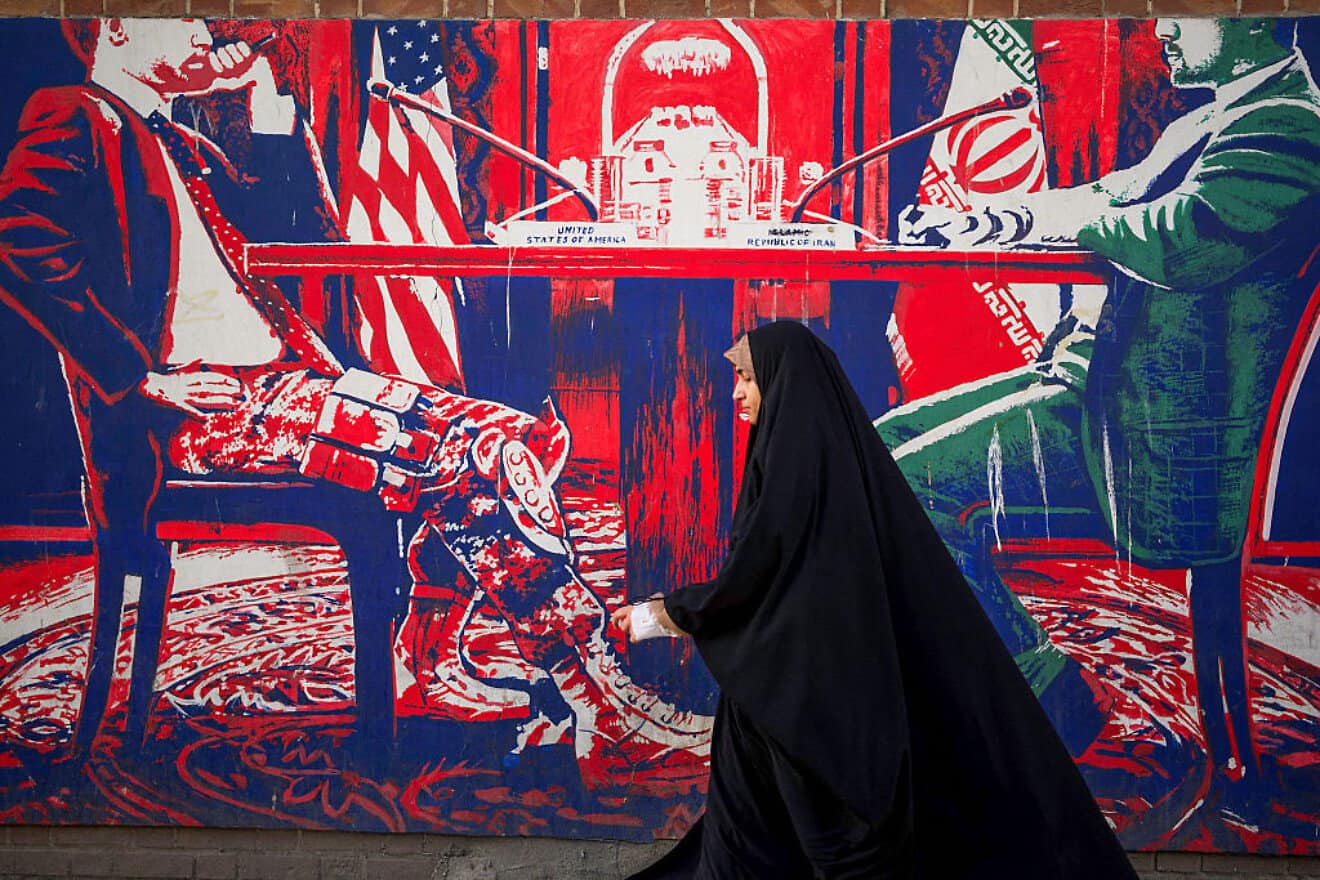 Iranians pass by anti-American murals painted on the walls of the former U.S. embassy in Tehran, April 16, 2025. Photo by Mohammadali Najib/Middle East Images/AFP via Getty Images.