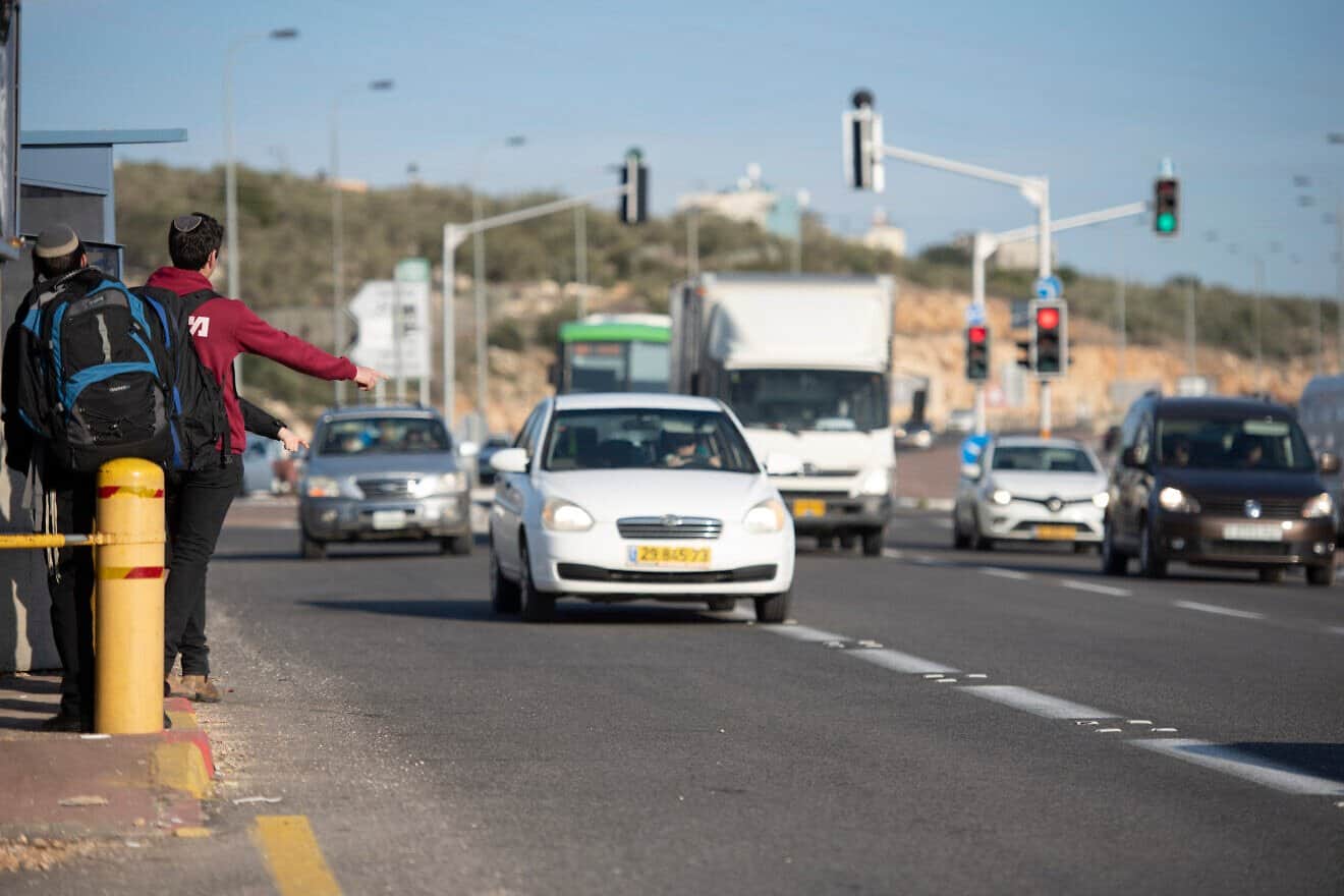 Jewish youth hitchhiking at Giti Avishar Junction on Route 5 in Samaria, Jan. 26, 2020. Photo by Sraya Diamant/Flash90.