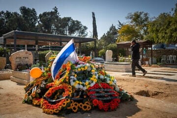 Mourners at the grave of murdered Israeli hostages Shiri Bibas and her children Ariel and Kfir at the cemetery in Tzohar in the Negev, Feb. 26, 2025. Photo by Chaim Goldberg/Flash90.