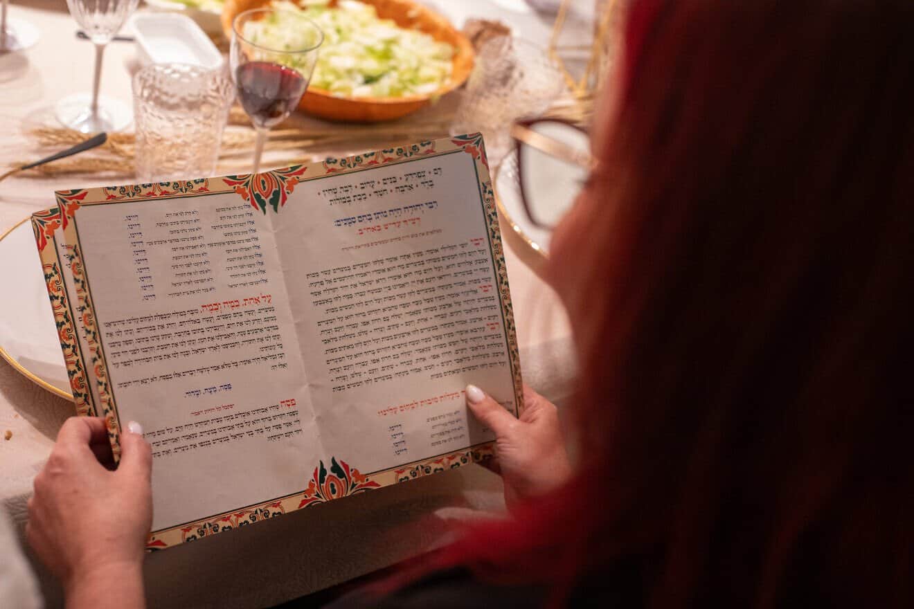 An Israeli family reading the Haggadah at a Passover Seder, April 22, 2024. Photo by Chen Leopold/Flash90. April 22, 2024.