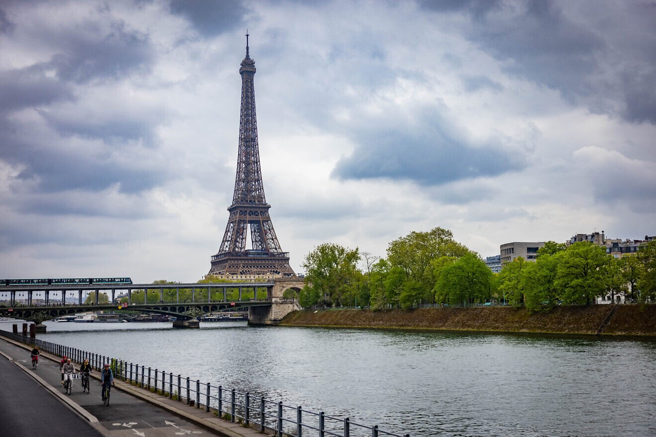 People ride bicycles near the Eiffel Tower in Paris on April 13, 2025. Photo by Yonatan Sindel/Flash90.