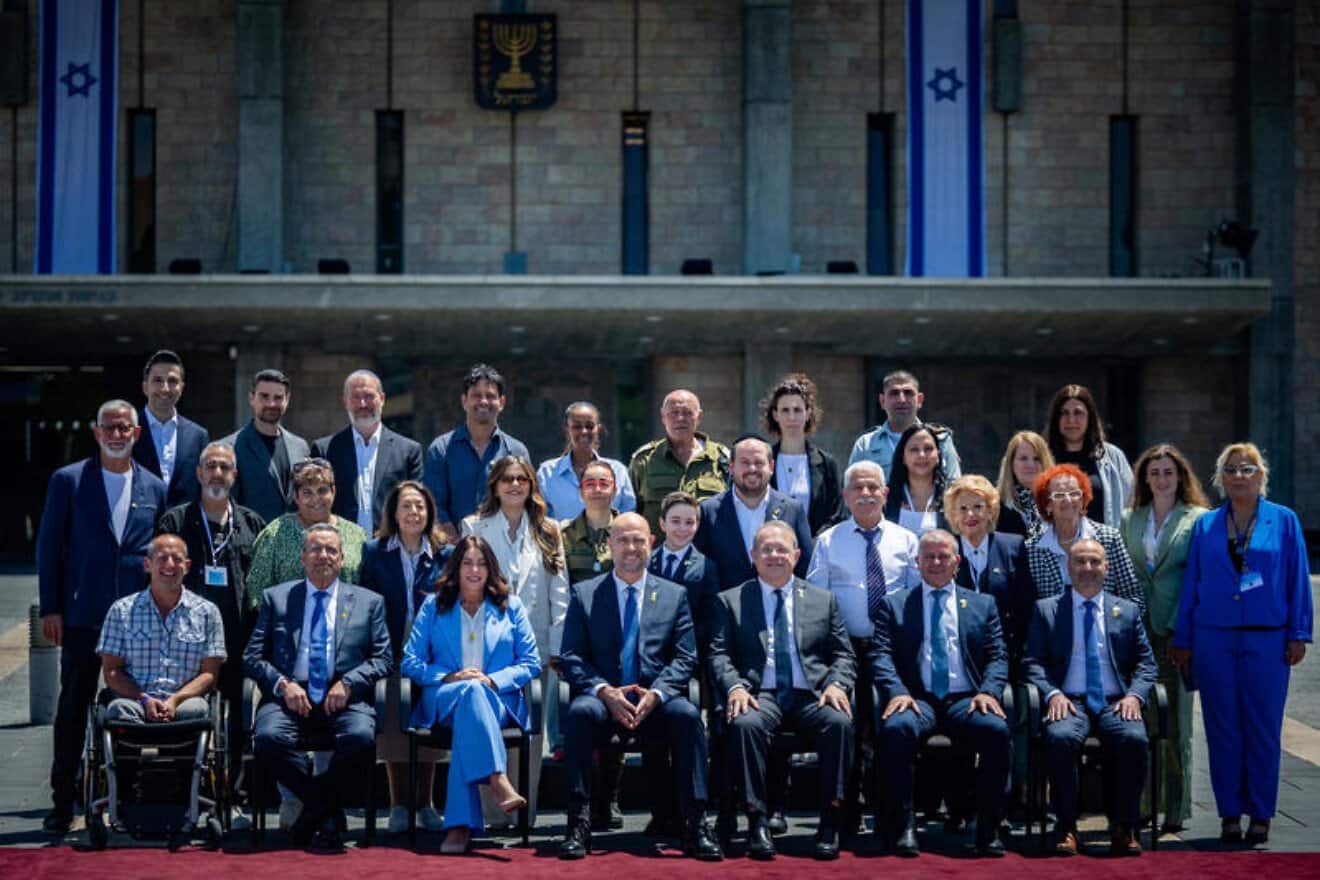 Knesset Speaker Amir Ohana (center-left) and Israeli Transportation Minister Miri Regev (third from left front row) pose for a group picture with the torch lighters of the Independence Day state ceremony, at the Knesset, the Israeli parliament in Jerusalem, on April 28, 2025. (Credit: Yonatan Sindel/Flash90