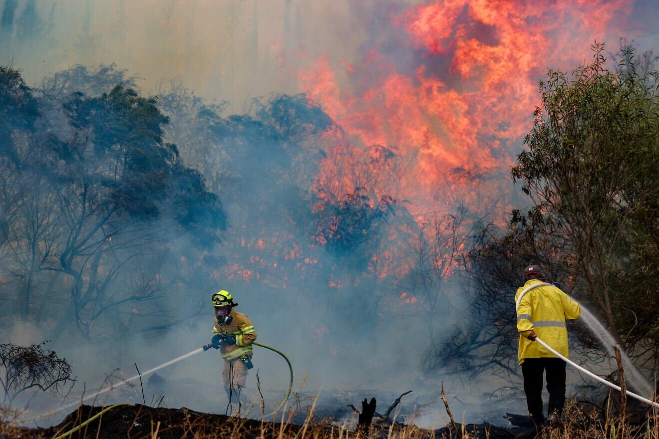 Firefighters try to extinguish a fire which broke out near Moshav Mesilat Zion, April 30, 2025. Photo by Noam Revkin Fenton/Flash90.