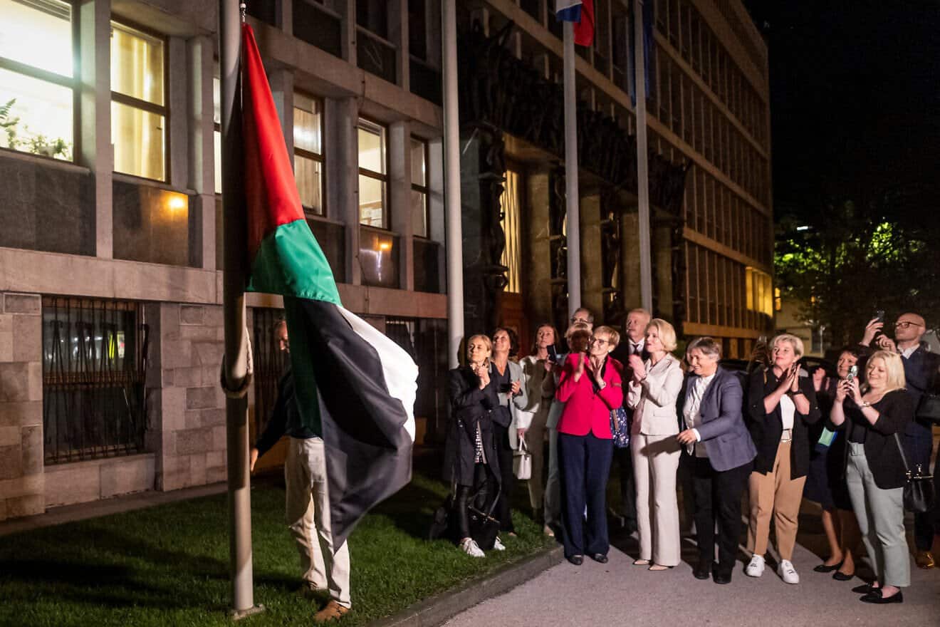 People hang a Palestinian flag in front of the Parliament building after Slovenia's National Assembly recognized the Palestinian state following a parliamentary vote in Ljubljana, on June 4, 2024. Photo by AFP via Getty Images.