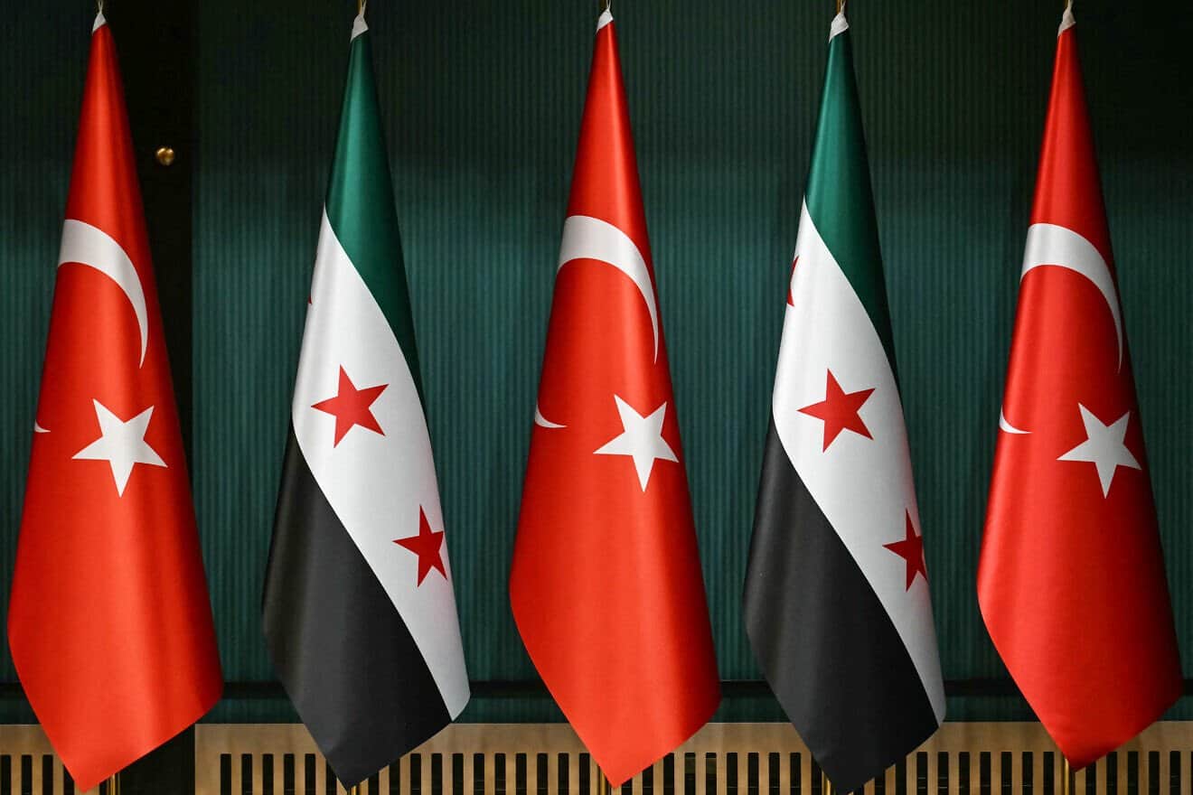 The flag of Turkey and the recently adopted flag of the Syrian Arab Republic are seen before a press conference by the Turkish president and Syrian interim president, following their meeting at the Presidential Palace in Ankara, on Feb. 4, 2025. Photo by Ozan Kose/AFP via Getty Images.