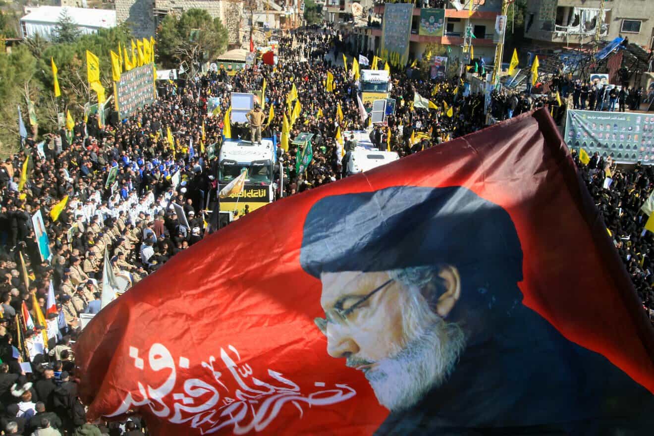 A banner bearing a portrait of slain Hezbollah chief Hassan Nasrallah waves during a funeral of terrorists in the southern Lebanese border town of Aitaroun, Feb. 28, 2025. Photo by Mahmoud Zayyat/AFP via Getty Images.