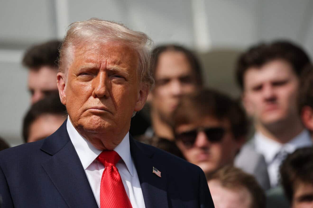 U.S. President Donald Trump listens as Ohio State Head coach Ryan Day speaks as he welcomes the 2025 College Football National Champions from Ohio State University to the White House during a ceremony on the south lawn on April 14, 2025 in Washington, D.C. Photo by Win McNamee/Getty Images.