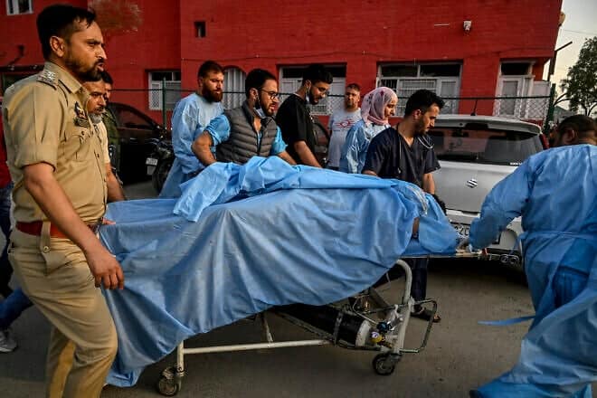 Paramedics and police personnel in India carry an injured tourist at a hospital in Anantnag, south of Srinagar, following an attack by gunmen in Indian-administered Kashmir, who opened fire on a group of tourists on April 22, 2025. Photo by Tauseef Mustafa/AFP via Getty Images.