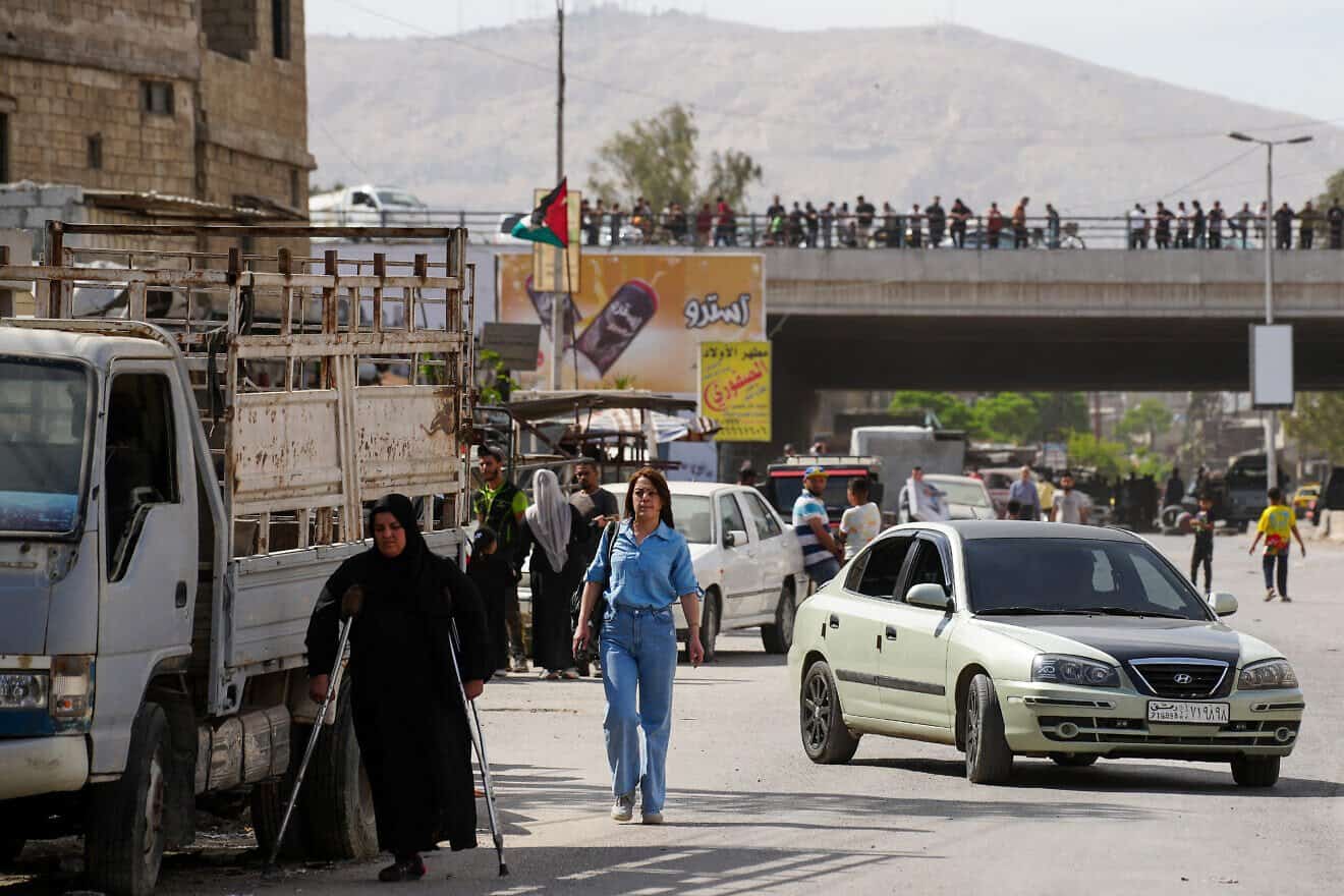 Two women walk in an area controlled by Syria's new Islamist government forces, in the Damascus' suburb of Jaramana, on April 29, 2025. Photo by Rami al Sayed/AFP via Getty Images.