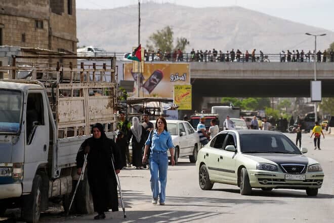 Two women walk in an area controlled by Syria's new Islamist government forces, in the Damascus' suburb of Jaramana, on April 29, 2025. Photo by Rami al Sayed/AFP via Getty Images.