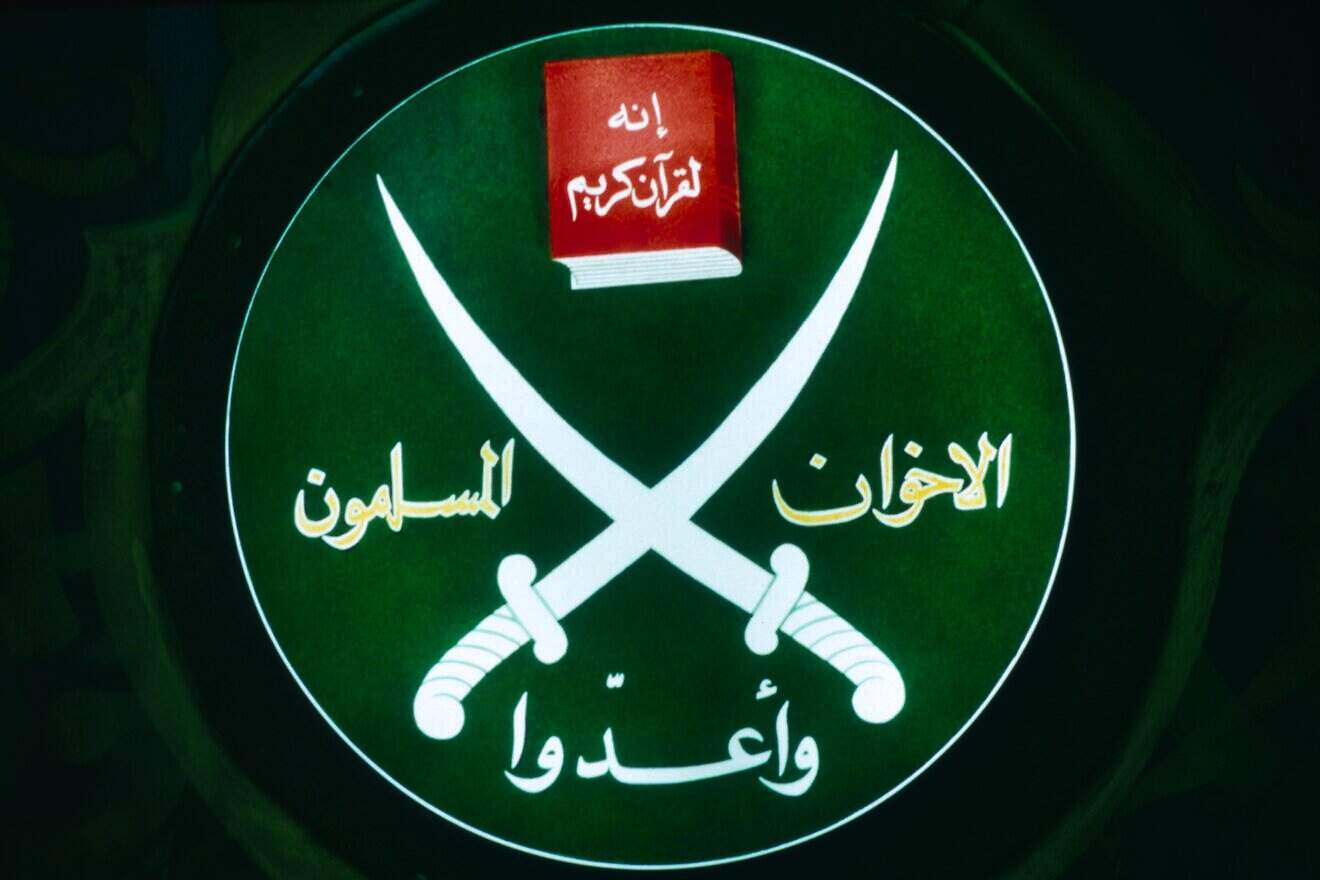Emblem of the fundamentalist Islamic movement founded in 1928, Society of the Muslim Brothers, on display during a press conference in their Cairo office. Photo by Maher Attar/Sygma via Getty Images.