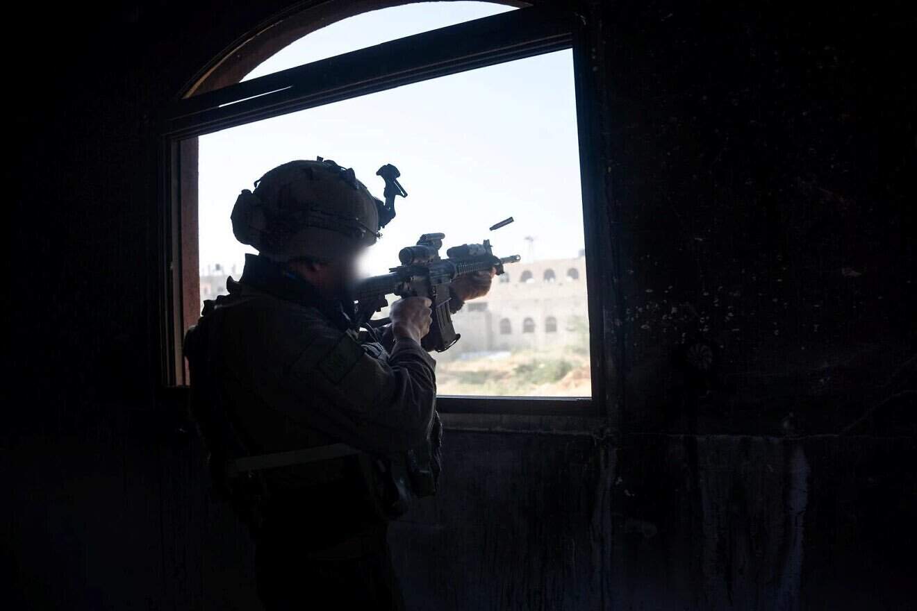 A Golani Brigade infantry soldier of the IDF is seen in a building in an undisclosed location in the Gaza Strip, on April 8, 2025. Credit: IDF.