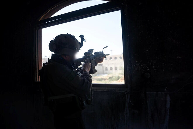 A Golani Brigade infantry soldier of the IDF is seen in a building in an undisclosed location in the Gaza Strip, on April 8, 2025. Credit: IDF.