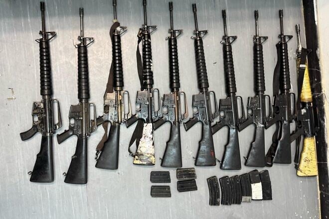 Confiscated M16 assault rifles and ammunition recovered by IDF troops after intercepting a drone smuggling operation along the Israel-Egypt border. Credit: IDF.