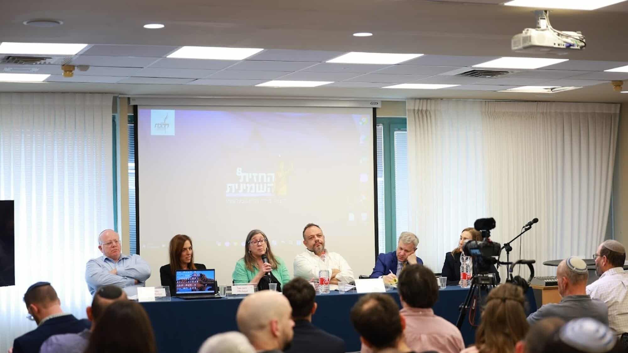 NGO Monitor legal adviser Anne Herzberg speaks at the Kohelet Policy Forum conference in Jerusalem, flanked by, from left, Prof. Amichai Cohen, International Legal Forum director Yifa Segal, former Israeli Foreign Ministry legal adviser Tal Becker, JCFA president Dan Diker and Jerusalem Press Club CEO Talia Dekel-Fleissig, April 7, 2025. Photo by Eliav Mayson/Kohelet Forum.