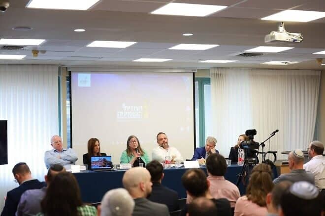 NGO Monitor legal adviser Anne Herzberg speaks at the Kohelet Policy Forum conference in Jerusalem, flanked by, from left, Prof. Amichai Cohen, International Legal Forum director Yifa Segal, former Israeli Foreign Ministry legal adviser Tal Becker, JCFA president Dan Diker and Jerusalem Press Club CEO Talia Dekel-Fleissig, April 7, 2025. Photo by Eliav Mayson/Kohelet Forum.