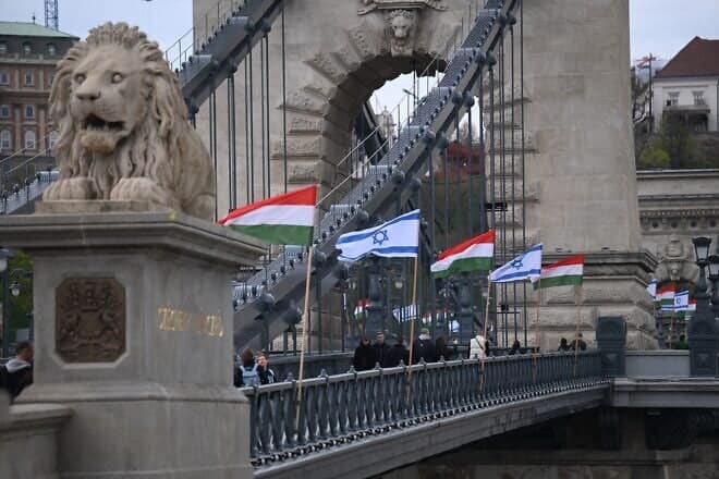 Israeli and Hungarian National flags are raised on the oldest Hungarian bridge, the Széchenyi Chain Bridge in Budapest, as preparations are under way for the visit of Israeli Prime Minister Benjamin Netanyahu, who is scheduled for talks with Hungary's Prime Minister Viktor Orbán and other senior Hungarian officials from April 2 to 6, 2025. Photo by Attila Kisbenedek/AFP via Getty Images.