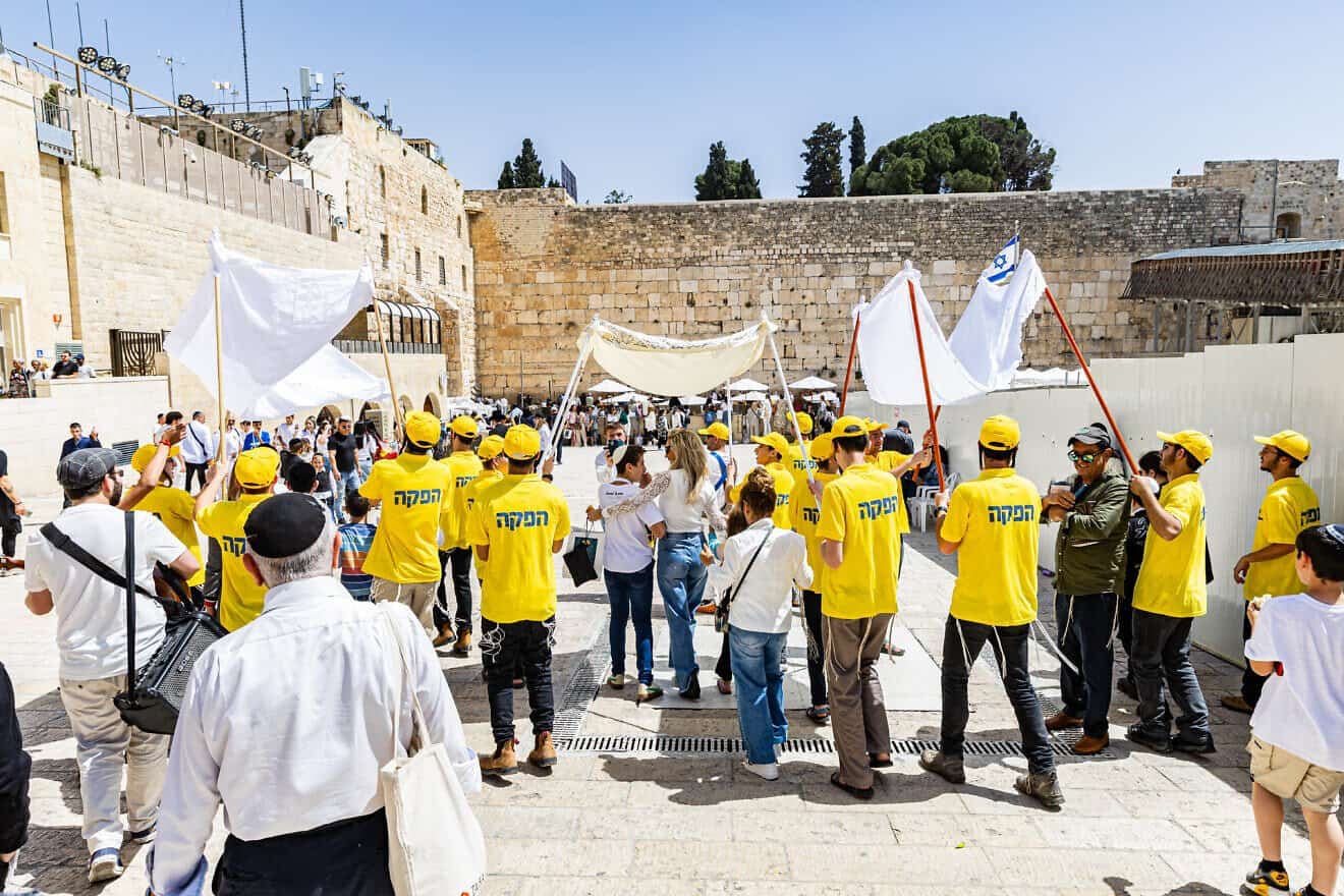 A widow in Israel escorts her son down towards the Western Wall in Jerusalem, joined by Colel Chabad volunteers, where he is called to the Torah for his bar mitzvah, April 3, 2025. Photo by Mendy Kornet.