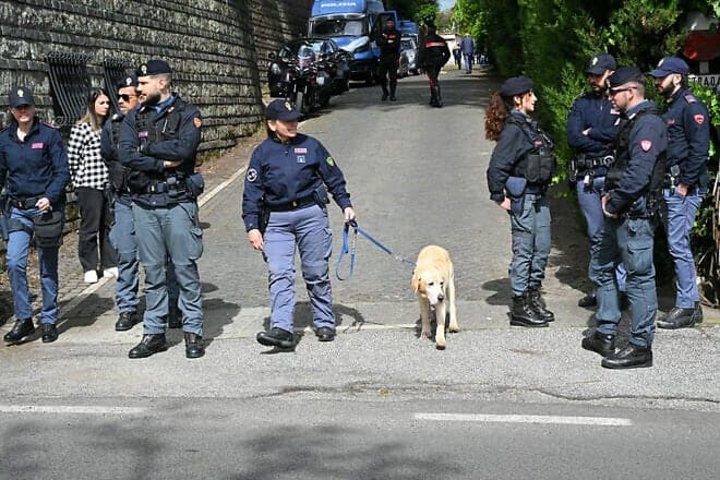 Police officers with a sniffer dog near the Omani embassy in Rome before a second round of nuclear talks there between Iran and the United States on April 19, 2025. Photo by Andreas Solaro/AFP via Getty Images.
